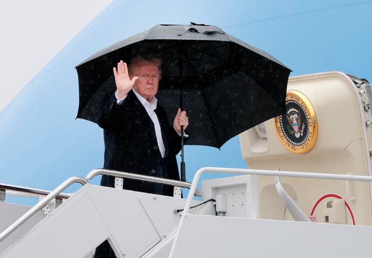 President Donald Trump waves as he boards Air Force One on April 11, 2025, at Joint Base Andrews, Maryland. 