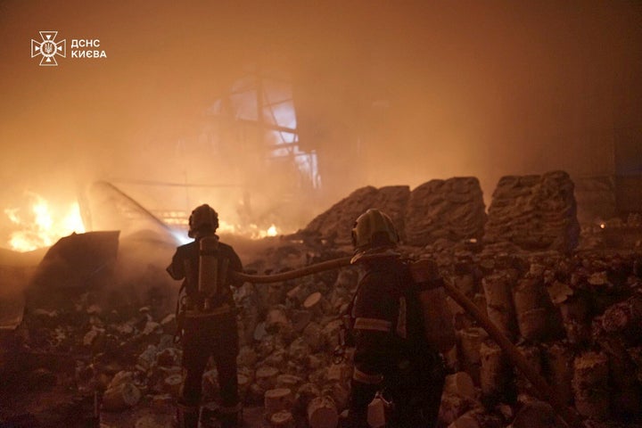 In this photo provided by the Ukrainian Emergency Service, emergency services personnel work to extinguish a fire following a Russian attack in Kyiv, Ukraine, Saturday, April 12, 2025. (Ukrainian Emergency Service via AP)
