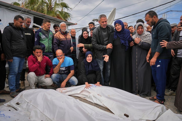 Relatives mourn over the bodies of Abdullah Habbash, along with the bodies of six brothers from the Abu Mahadi family, all members of a Palestinian charity organization linked to Hamas, who were killed earlier in an Israeli army strike on the car they were traveling in, in Deir al-Balah, central Gaza Strip, Sunday, April 13, 2025. (AP Photo/Abdel Kareem Hana)"