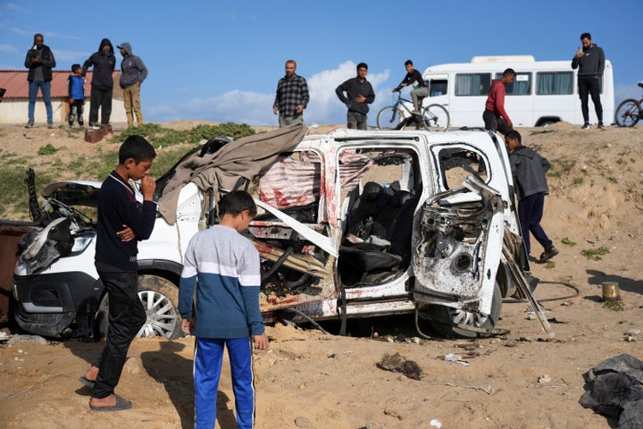 Israel Intensifies Strikes Throughout Gaza On Palm Sunday And Hits A Hospital In The North 1 Palestinians look at the wreckage of a car struck earlier by an Israeli army attack that killed at least seven people, six of them the Abu Mahadi brothers, in the outskirts of Deir al-Balah, central Gaza Strip, Sunday, April 13, 2025. (AP Photo/Abdel Kareem Hana)