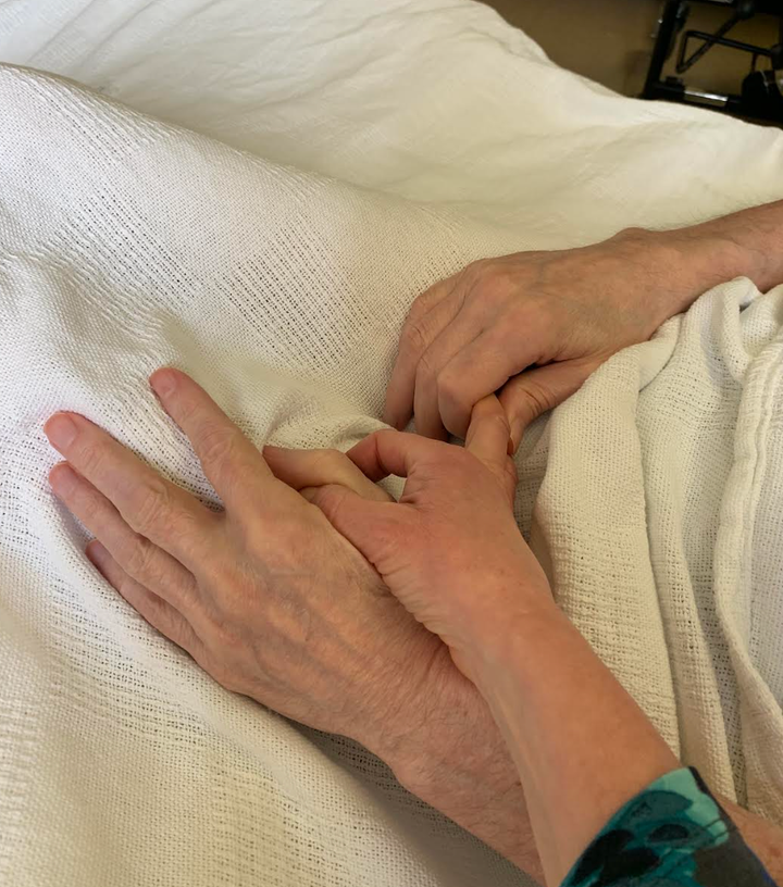 The author holds hands with her partner, Steve.