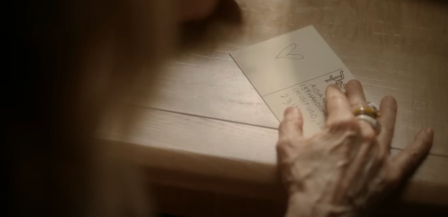 Carrie sends Aidan a postcard in And Just Like That
