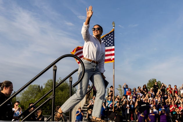 Representative Alexandria Ocasio-Cortez (Democrat, New York) waves to the crowd during a stop of the 'Fighting Oligarchy' rally at Folsom lake College in Folsom, Calif., Tuesday, April 15, 2025.