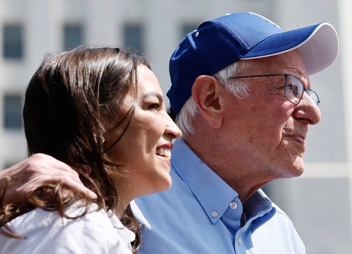 Sen. Bernie Sanders (I-Vt.) and Rep. Alexandria Ocasio-Cortez (D-N.Y.) look toward the crowd during a stop on their ‘Fighting Oligarchy’ tour at Grand Park on April 12 in Los Angeles, California.