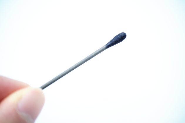 Image material of a hand holding a cotton swab