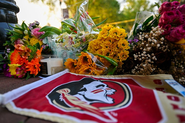 Students hold a vigil near the scene of a shooting at the Florida State University student center on April 17 in Tallahassee, Florida. Two people were killed and several others injured when the alleged shooter, believed to be a current student and the son of a Leon County sheriff's deputy, opened fire on the university's main campus.