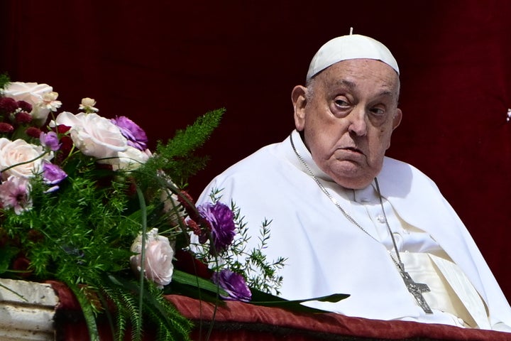 Pope Francis stands on the main balcony of St. Peter's Basilica during the Urbi et Orbi message and blessing to the city and the world Sunday as part of Easter celebrations at St Peter's Square in the Vatican.