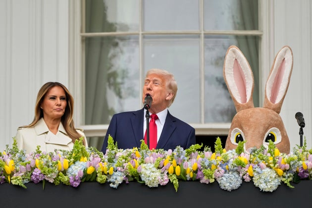 Donald Trump and first lady Melania Trump stand on the Blue Room Balcony as they participate in the White House Easter Egg Roll.