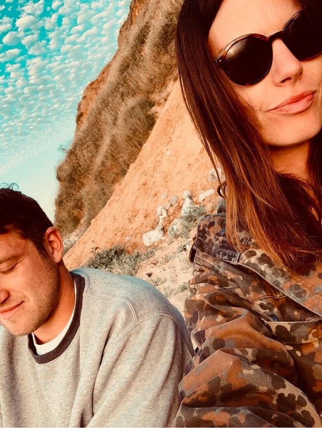 The author and her partner on the beach, the night they found out she was pregnant with their first child.