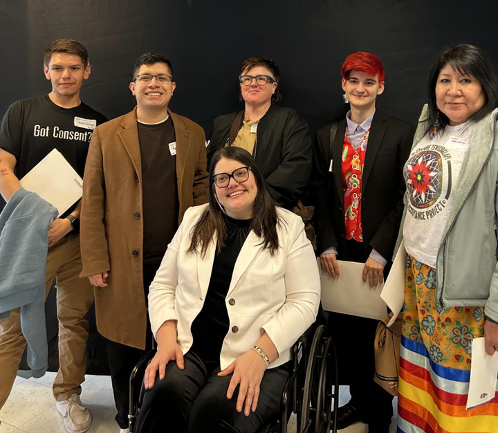 Dr. Katie Edwards (center front) poses with members of the Interpersonal Violence Research Laboratory and her wife at a professional meeting in New York City in March 2025.