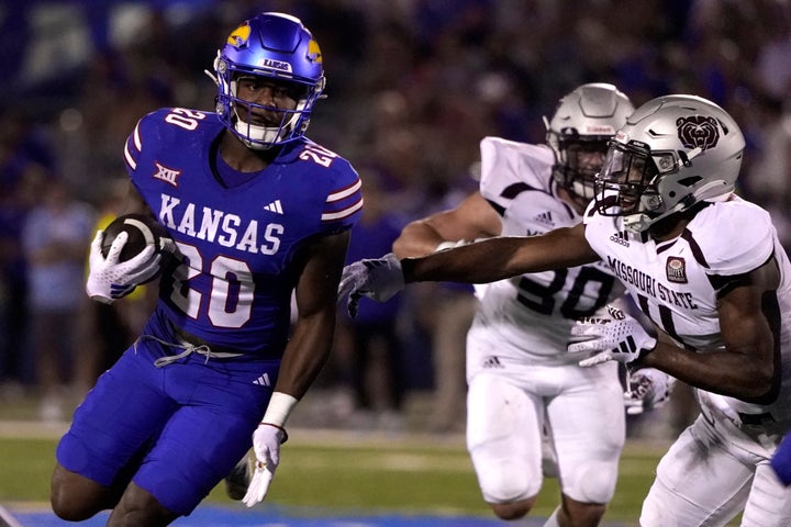 McGee (right), trying to stop Daniel Hishaw Jr. of the Kansas Jayhawks in September 2023. 