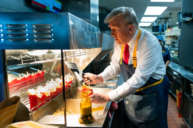 Donald Trump works behind the counter during a campaign event at McDonald's restaurant on October 20, 2024 