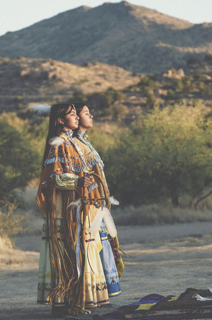 At sunrise, the author, left, with her partner, her sister Sage Parsons, begins the journey during her coming-of-age ceremony with the first songs by the medicine men and singers at Oak Flat.