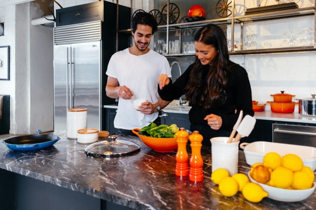 Man and woman preparing food.