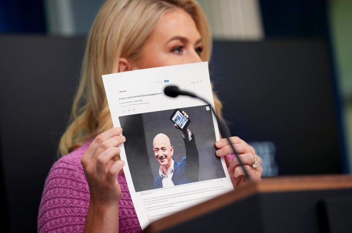 White House press secretary Karoline Leavitt holds a news article on Amazon CEO Jeff Bezos as she speaks to reporters on April 29, 2025, in Washington, D.C.