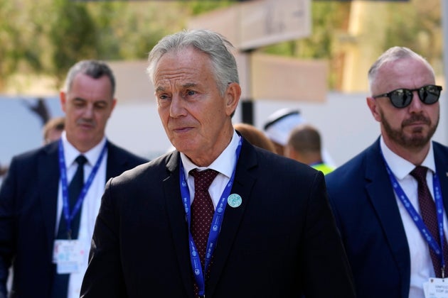 Former Prime Minister Tony Blair walks through the COP28 UN Climate Summit, Sunday, Dec. 3, 2023, in Dubai, United Arab Emirates.