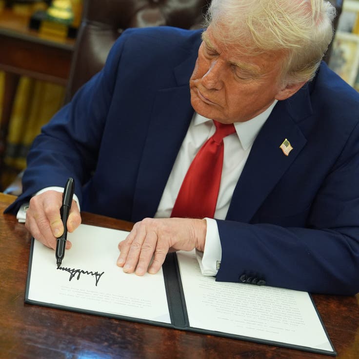President Donald Trump signs an executive order in the Oval Office of the White House on Feb. 3 in Washington.