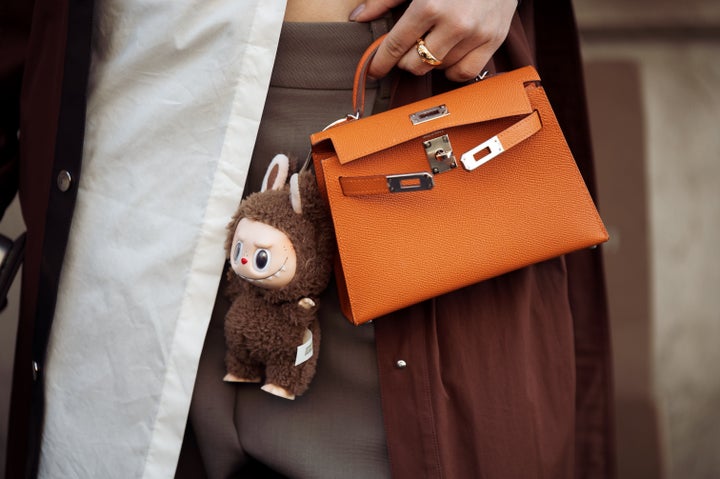 At Paris Fashion Week this year, a guest paired her orange Hermes bag with a a Labubu monster. Very chic.