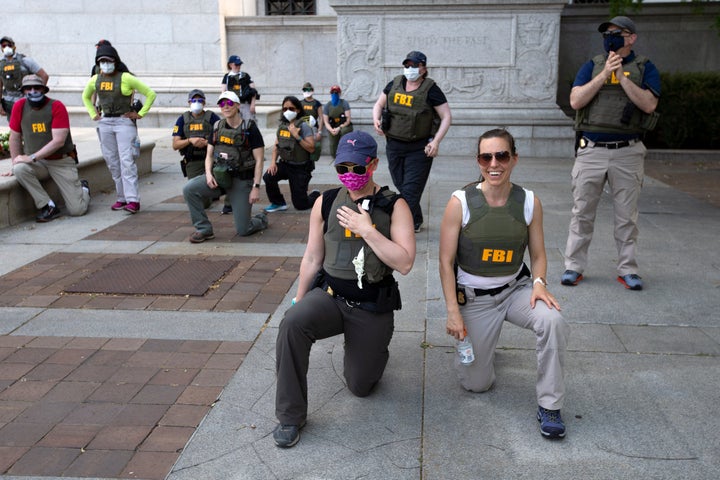 FBI officers took a knee with demonstrators at a DC protest in 2020 following the police killing of George Floyd.