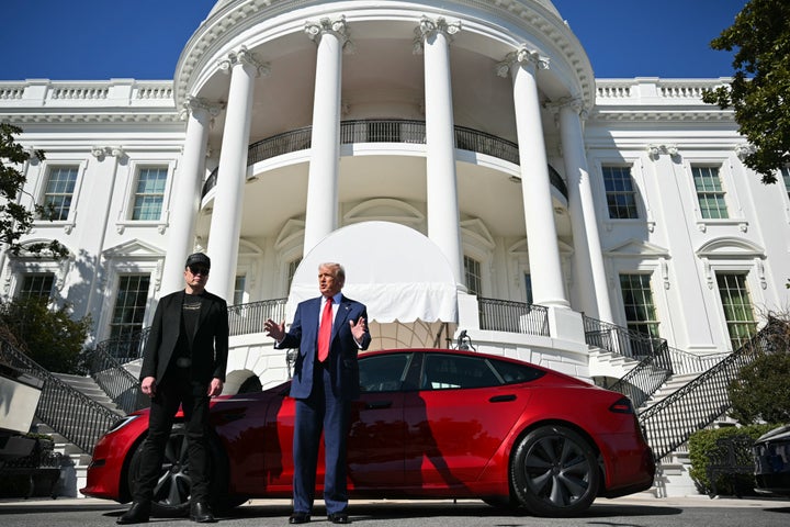 President Donald Trump and Tesla CEO Elon Musk speak to the press as they stand next to a Tesla vehicle on the South Portico of the White House on March 11 in Washington, D.C.