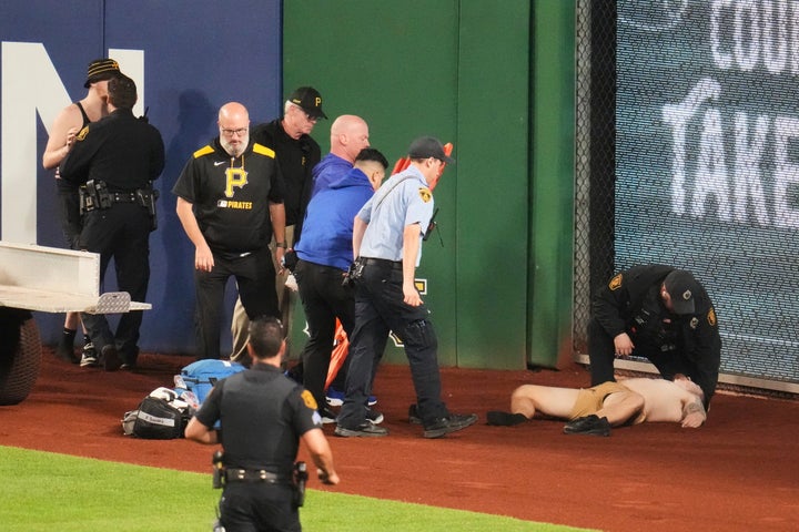 The injured fan lies on the warning track in right field of PNC Park after falling out of the stands.