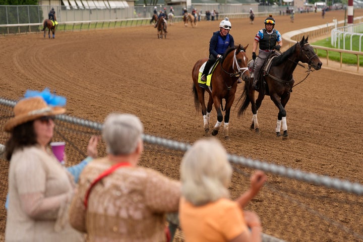 People watch Kentucky Derby entrant Journalism during a workout at Churchill Downs Wednesday, April 30, 2025, in Louisville, Ky. (AP Photo/Charlie Riedel)