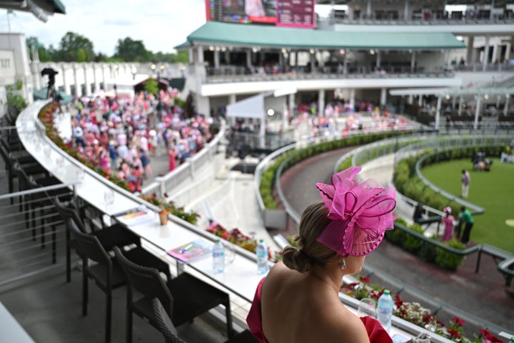 A fan looks out at the paddock at Churchill Downs before the 151st running of the Kentucky Oaks horse race Friday, May 2, 2025, in Louisville, Ky. (AP Photo/Jon Cherry)