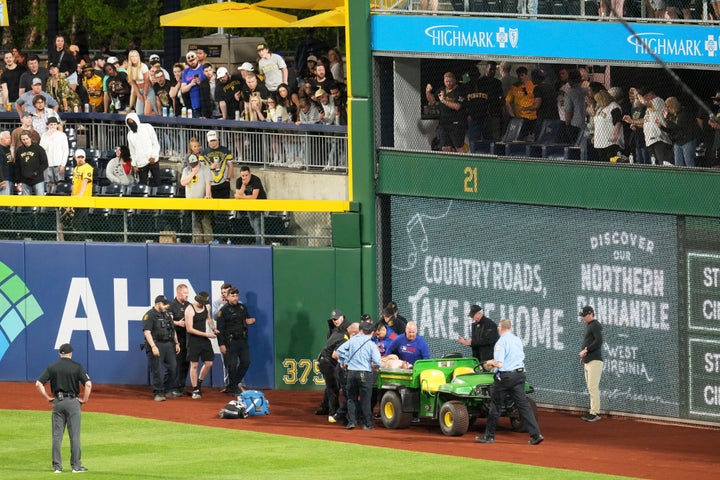 A fan is carted of the field at PNC Park after falling out of the stands during the seventh inning of a baseball game between the Pittsburgh Pirates and the Chicago Cubs in Pittsburgh, Wednesday, April 30, 2025. (AP Photo/Gene J. Puskar)