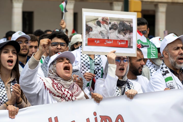 Moroccans in Rabat protest Israel's latest offensive in Gaza and U.S. President Donald Trump's proposal to displace Palestinians and clear the territory for development, on April 6, 2025. The placard in Arabic reads "Save Gaza's children."
