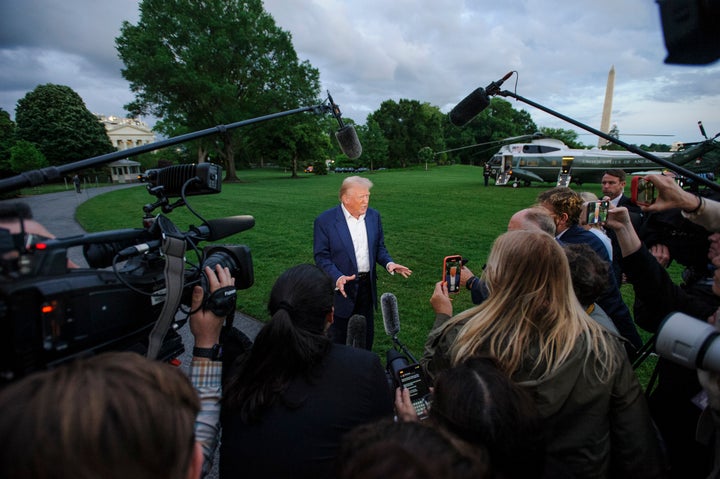 President Donald Trump speaks with reporters after disembarking Marine One upon arrival on the South Lawn of the White House in Washington, Sunday, May 4, 2025. (AP Photo/Rod Lamkey, Jr.)