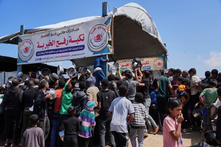 Israel Plans To Seize Gaza Underneath A New Plan, Officers Say 2 Palestinians struggle to get donated food at a community kitchen in Khan Younis, Gaza Strip, Monday, May 5, 2025. (AP Photo/Abdel Kareem Hana)