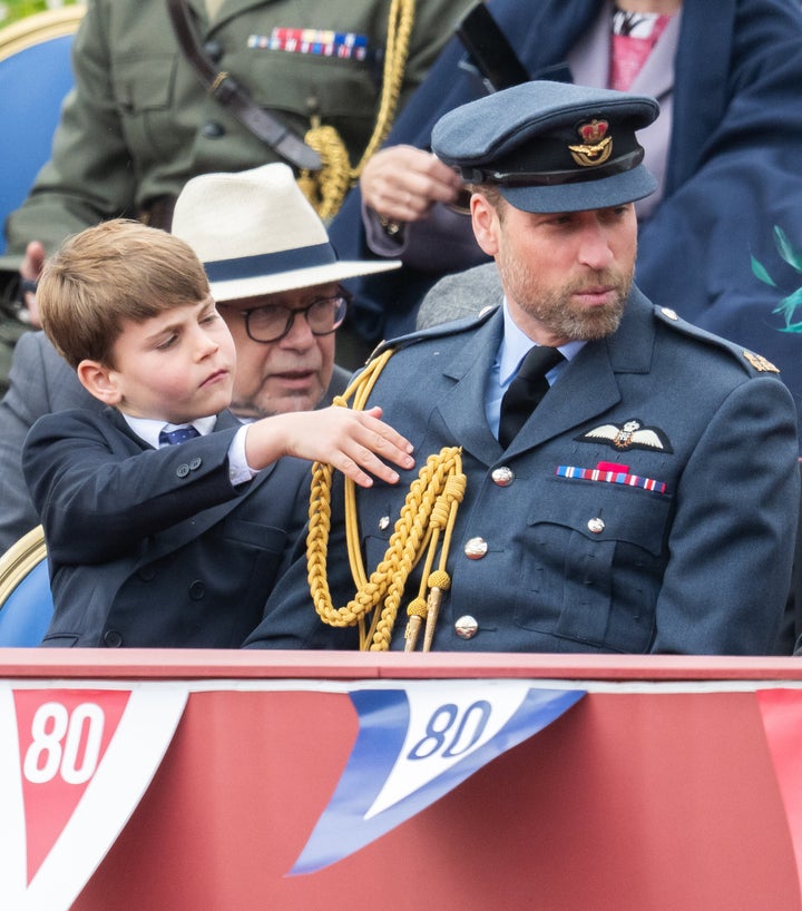 Louis taking an interest in his father's uniform.