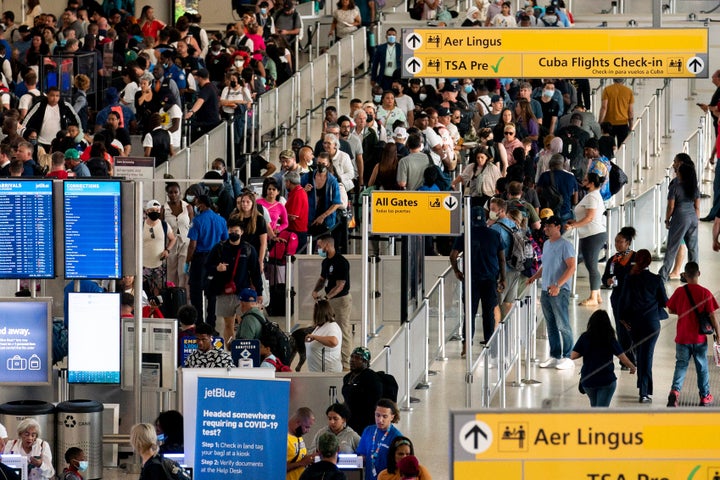 People wait in a TSA line at the John F. Kennedy International Airport on Tuesday, June 28, 2022, in New York. (AP Photo/Julia Nikhinson)