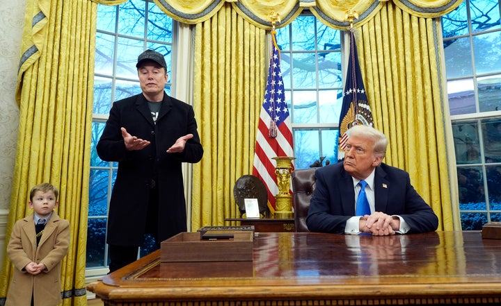President Donald Trump listens as Elon Musk, joined by his son X Æ A-Xii, speaks in the Oval Office at the White House. 
