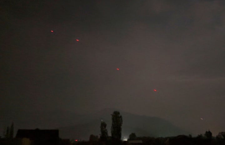 Red projectiles are seen over Srinagar, in Indian controlled Kashmir, Saturday, May 10, 2025. (AP Photo/Mukhtar Khan)