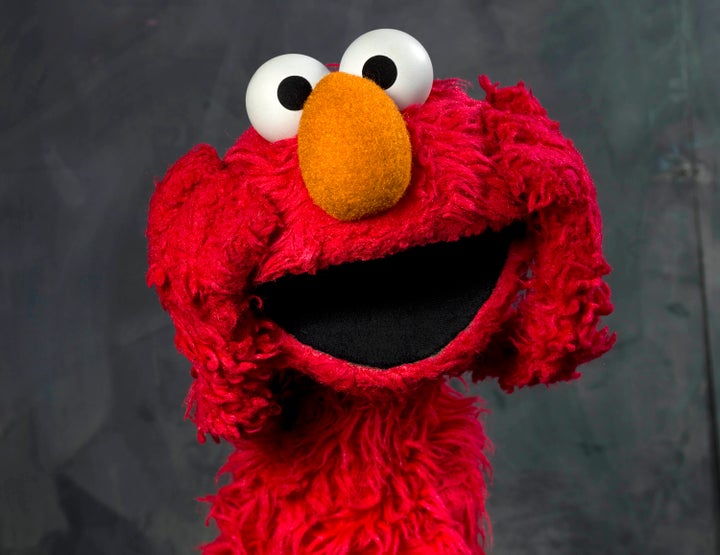 FILE - This Jan. 24, 2011 file photo shows "Sesame Street" muppet Elmo posing for a portrait with the assistance of puppeteer Kevin Clash in the Fender Music Lodge during the 2011 Sundance Film Festival to promote the documentary "Being Elmo" in Park City, Utah. (AP Photo/Victoria Will, file)