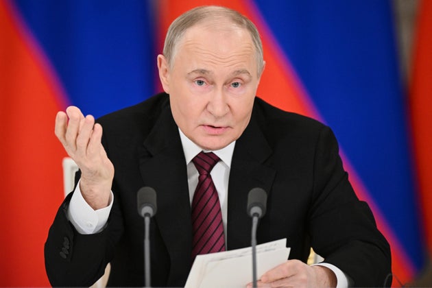 Russian President Vladimir Putin gestures as he speaks to journalists in the Grand Palace at the Kremlin in Moscow, Russia, Sunday, May 11, 2025.