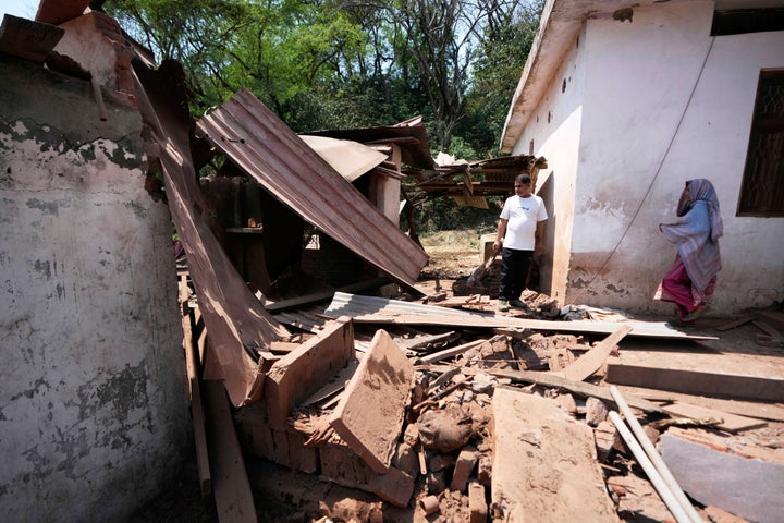 Residents inspect their house which was damaged by Pakistani artillery shelling on the outskirts of Jammu, India, Saturday, May 10, 2025. (AP Photo/Channi Anand)