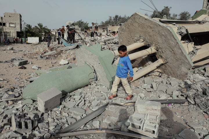 Palestinians search through the rubble of Al-Hasanat Mosque in Al-Nuseirat Refugee Camp, central Gaza, on Monday, which was targeted without prior warning.