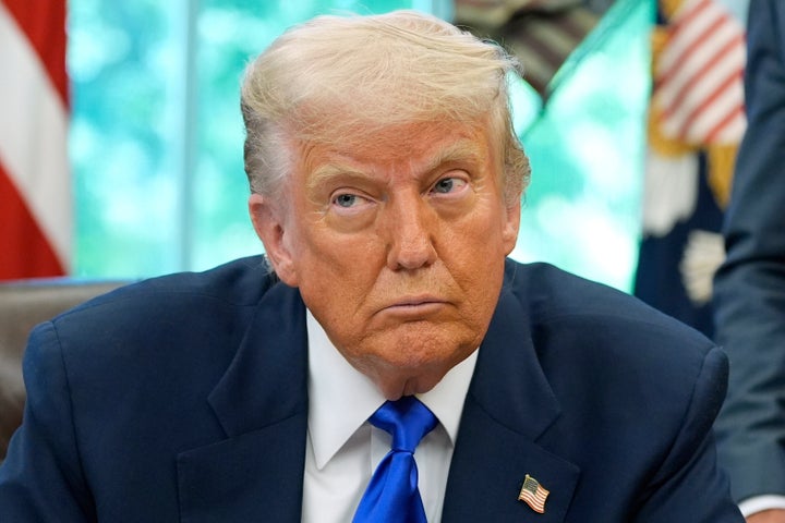 President Donald Trump speaks with reporters as he signs executive orders and proclamations in the Oval Office of the White House, on May 5 in Washington.