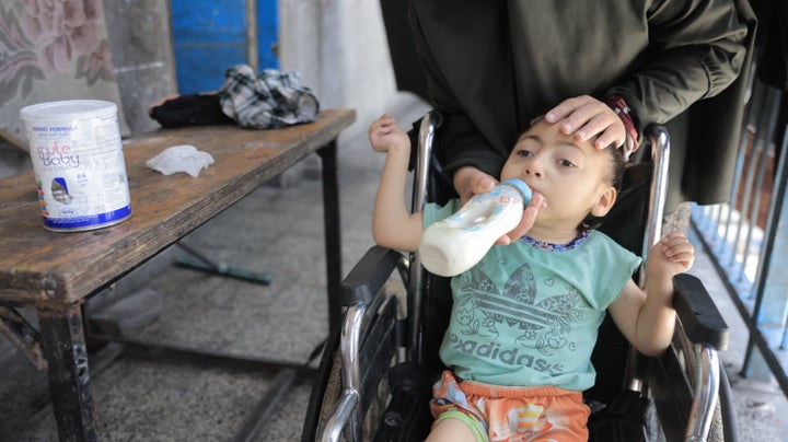 Esmahan Fuad Yousef al-Falouji tries to keep her 6-year-old malnourished daughter Renda Jihad Muhammad al-Falouji alive despite the lack of food and health services in North Gaza's Jabalia, on May 13, 2025. Renda has not been able to receive physical therapy for her paralysis due to Israeli attacks forcing the closure of a center serving disabled Palestinians.
