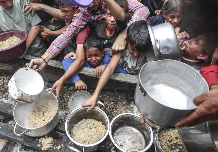Charities distribute hot meals to Palestinians in northern Gaza's Jabalia camp, on May 14, 2025. As Israel's relentless and devastating attacks on the Gaza Strip continue, Israeli policies have exacerbated the already severe humanitarian crisis in the region.