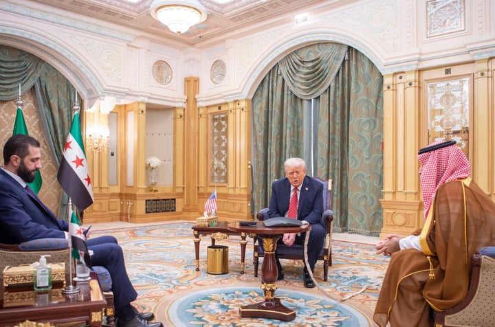 In this photo released by the Saudi Royal Palace, U.S. President Donald Trump meets with Syrian interim President Ahmad al-Sharaa, left, and with Saudi Crown Prince Mohammed bin Salman, right, in Riyadh, Saudi Arabia, on May 14, 2025. 