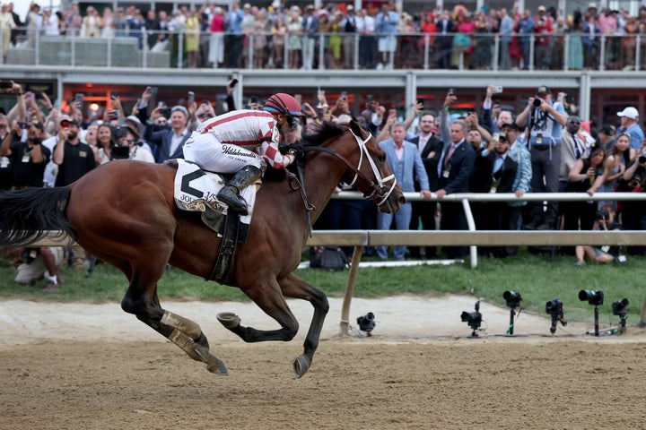 BALTIMORE, MARYLAND - MAY 17: Jockey Umberto Rispoli crosses the finish line on Journalism #2 to win the 150th Preakness Stakes at Pimlico Race Course on May 17, 2025 in Baltimore, Maryland. (Photo by Rob Carr/Getty Images)