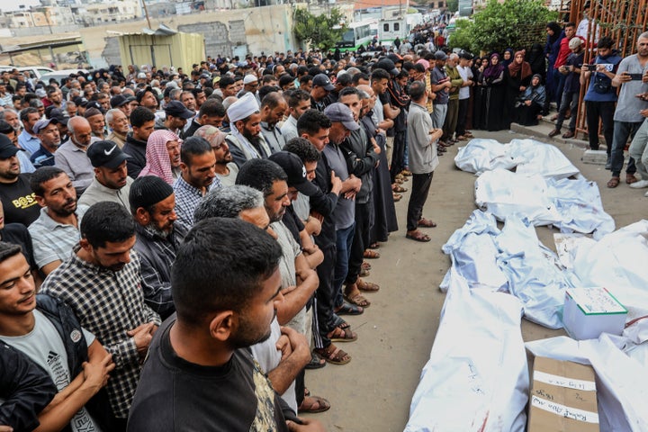 Palestinians mourn at a funeral for those killed by Israeli strikes in Khan Younis, Gaza, on May 18, 2025. The attacks killed more than 100 people, including children.