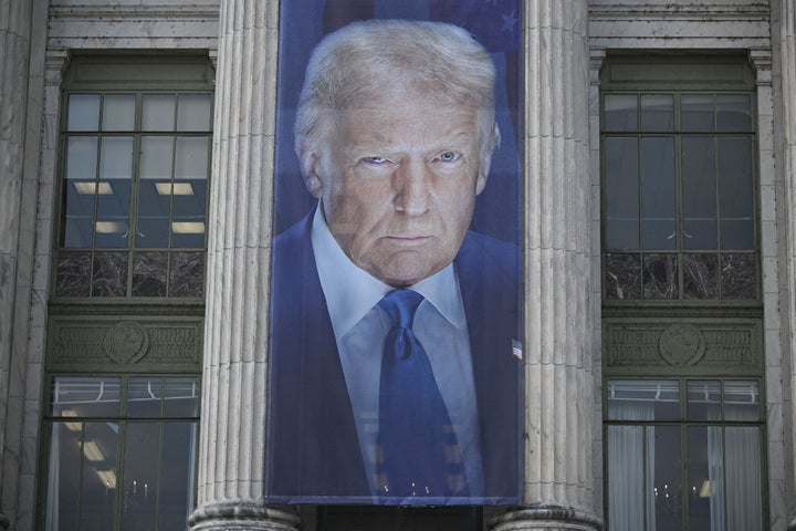 A banner showing an image of President Donald Trump hangs on the side of a U.S. Department of Agriculture building in Washington, D.C.