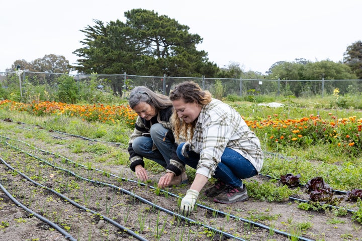 The Homeless Garden Project's mission is to enhance community engagement and reduce isolation among homeless people through educational and volunteer opportunities. Seen here is executive director Darrie Ganzhorn (left) working at the farm.