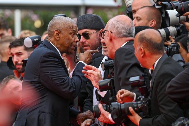 Denzel Washington has a tense exchange with a photographer on the "Highest 2 Lowest" red carpet at the 78th annual Cannes Film Festival on Monday in France.
