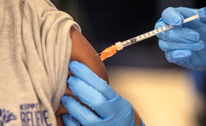 Medical personnel vaccinate students at a school in New Orleans on Jan. 25, 2022. (AP Photo/Ted Jackson, File)