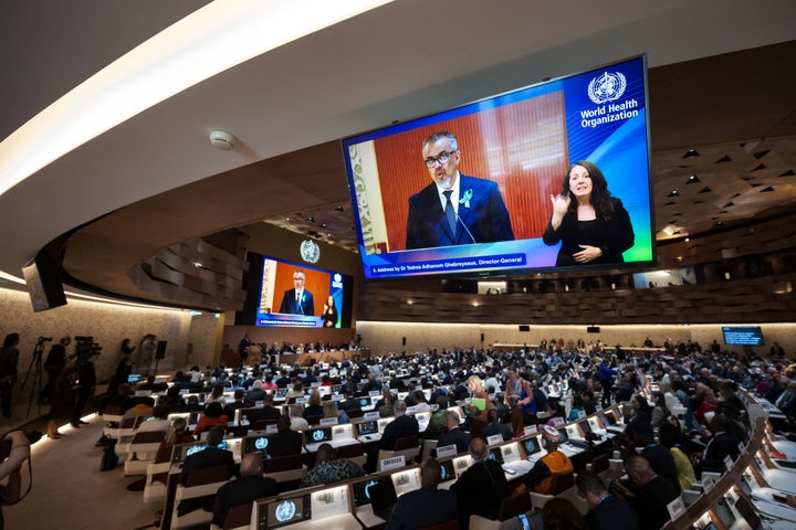 World Health OrganizationDirector-General Tedros Adhanom Ghebreyesus is seen on a screen delivering his report before delegates during the World Health Assembly in Geneva on May 19, 2025.